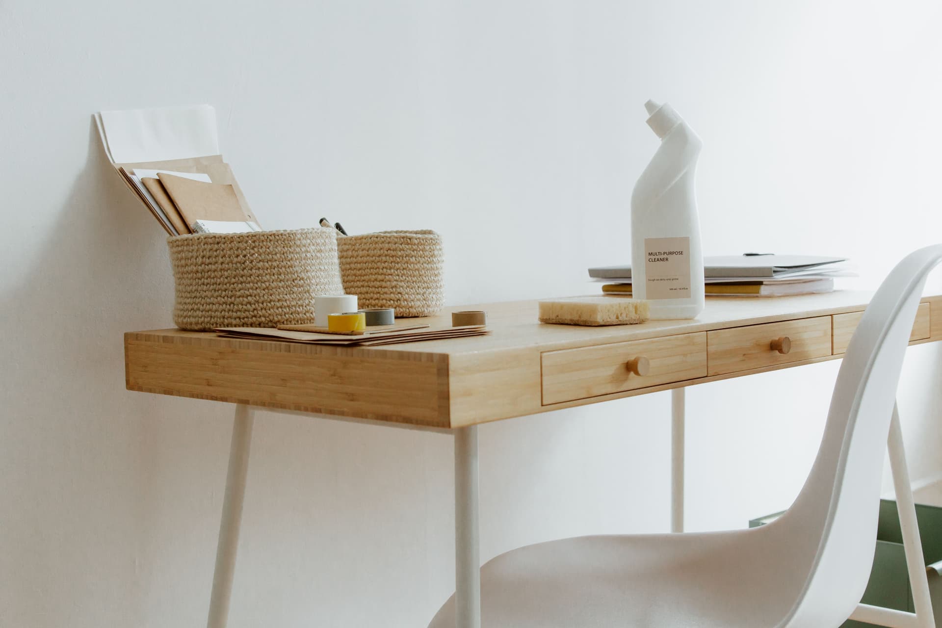 Tidy home office desk with cleaning supplies
