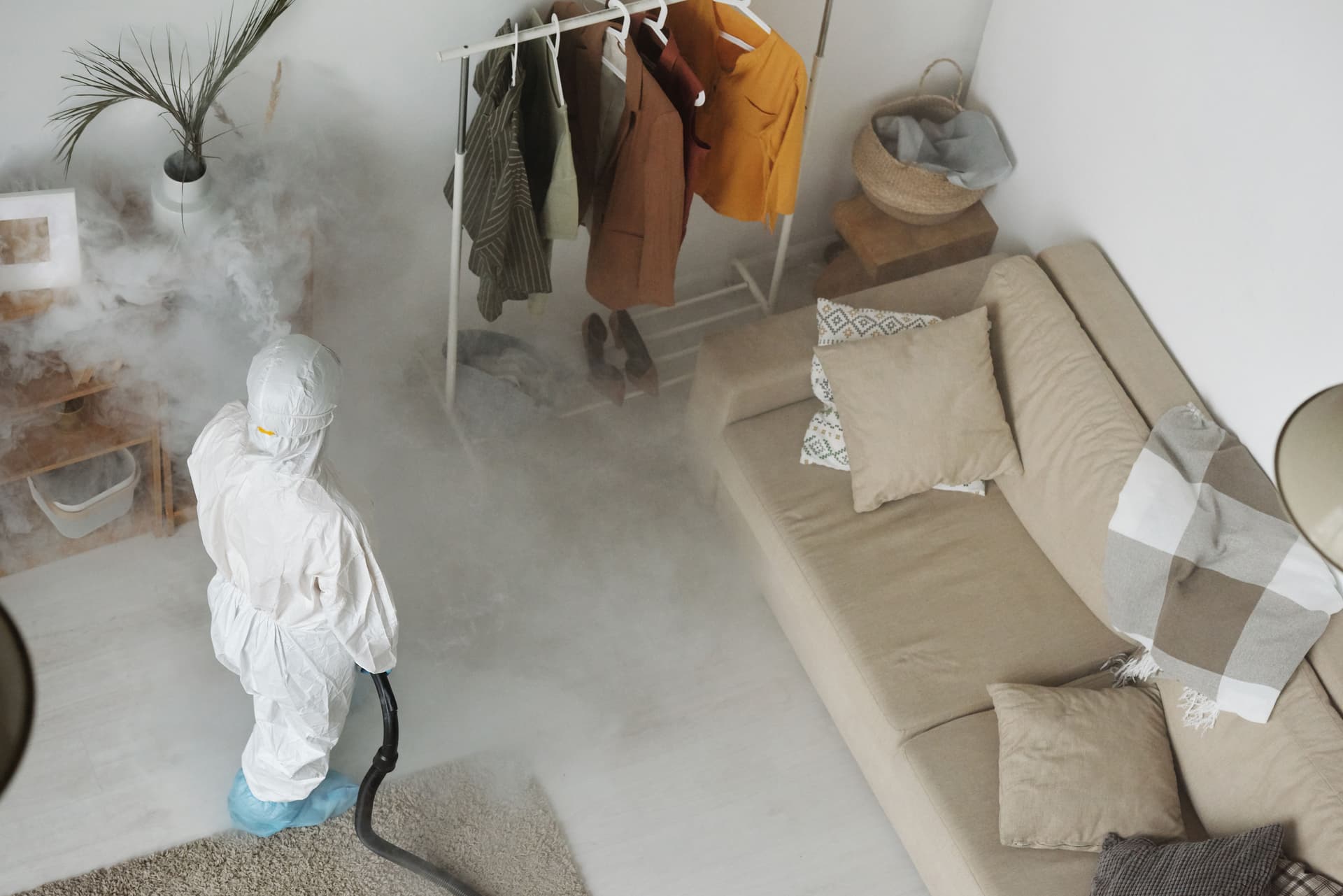 Technician fogging a residential living room for sanitization
