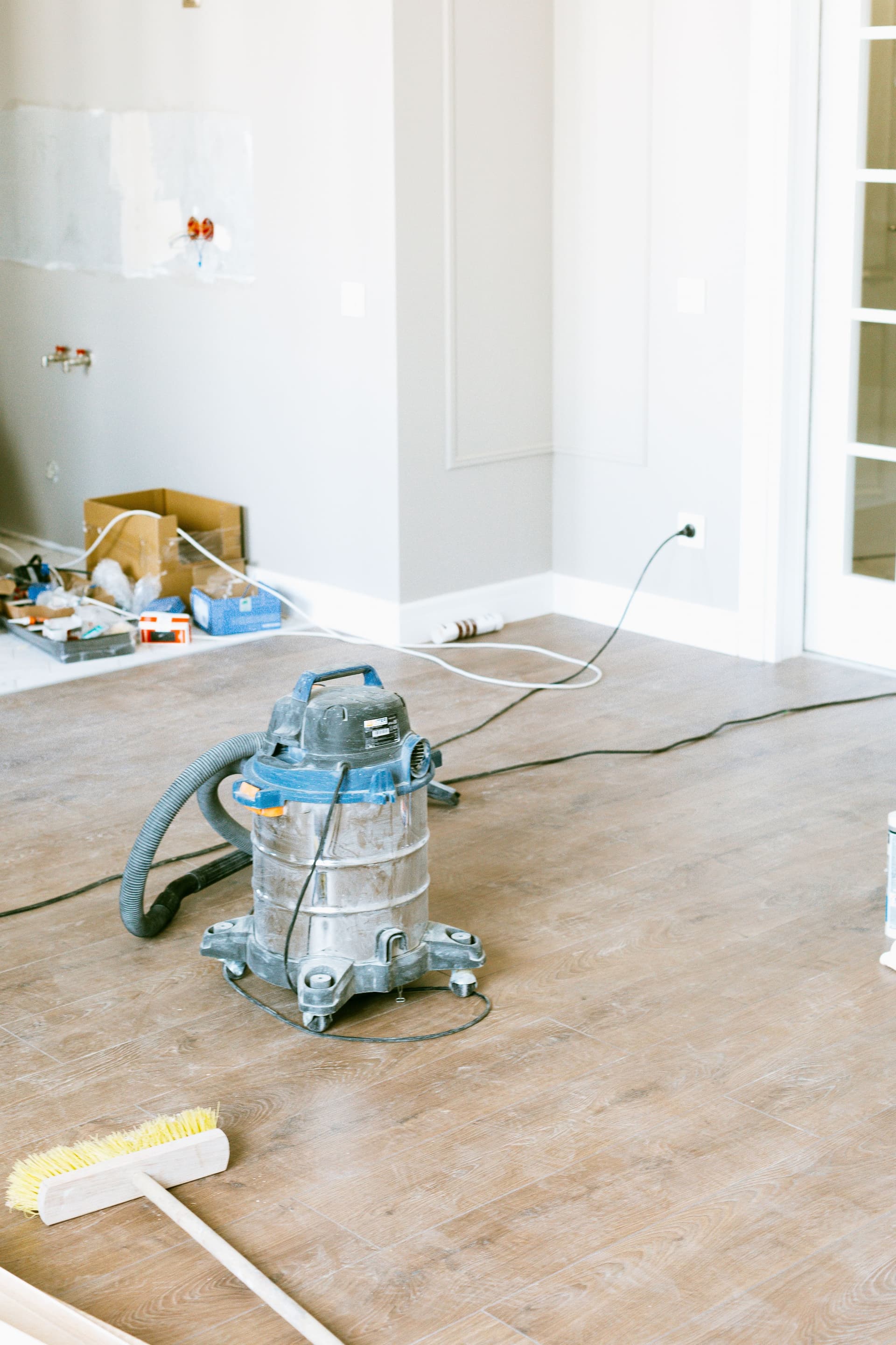 Post-construction clean with industrial vacuum in an unfinished room